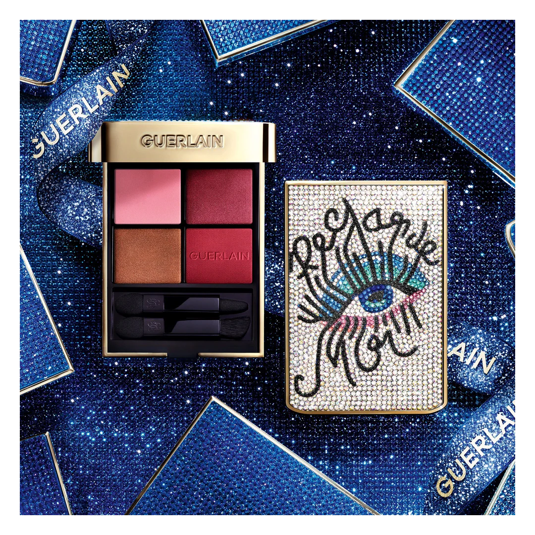 GUERLAIN Ombres G limited edition eyeshadow palette with jeweled eye motif case, featuring four pigmented shades and applicators, styled on a blue sparkling background — authentic luxury eyeshadow palette available at Exquisite Georgia.