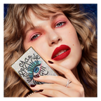 Model showcasing GUERLAIN Ombres G limited edition palette with jeweled eye motif case, featuring vibrant eye makeup and bold red lipstick — authentic luxury beauty collection available at Exquisite Georgia.