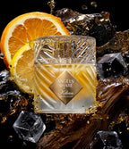 Kilian Angels' Share perfume bottle with ice cubes and oranges on a dark background
